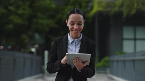 Office Worker Going to the Work Place and Browsing in the Internet on Tablet Lady Entrepreneur