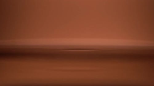 drop of water on the surface of the water on orange background close up