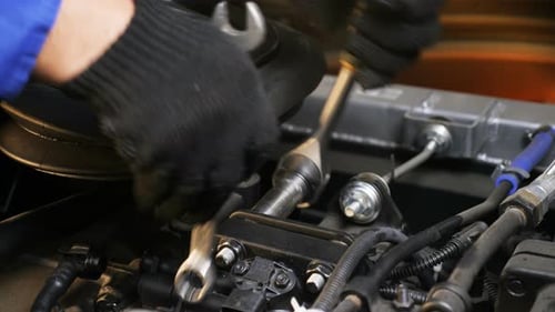 Skilled Worker Fixes Screws with Wrench on Motor Closeup