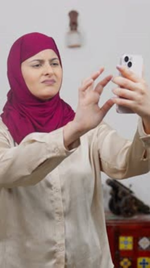 Vertical Video of Muslim Woman in Hijab Scarf Looking For Network in Phone