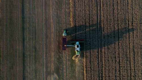 Aerial view of a tractor farming in an agricultural field in Belgium.