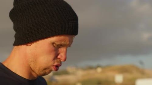 Young Adult Smiles on Overcast Beach