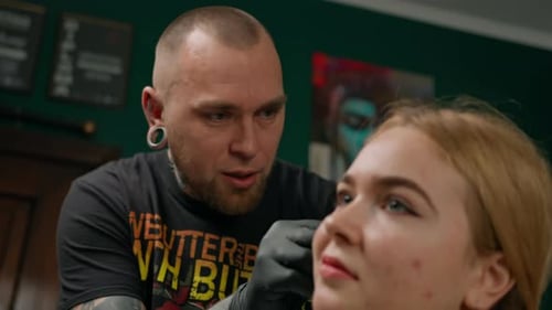 Piercing studio interior - piercing master makes a piercing to a girl, ear piercing