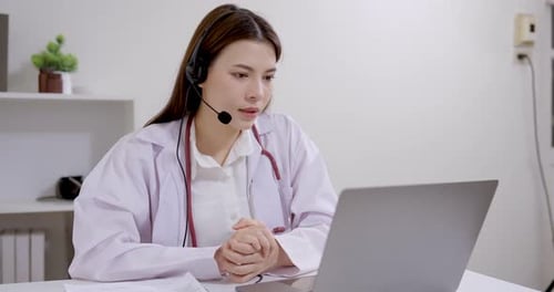 Female Doctor Telemedicine Consultation on Laptop in Office