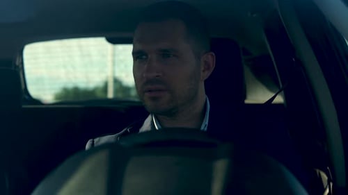 Handsome Young Man Sitting in the Car and Driving