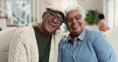 Senior Couple Smiling Together in Living Room