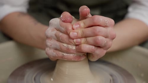 Hands Shaping Clay on a Pottery Wheel