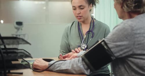 Doctor taking Senior Patient Blood pressure in Doctors Office