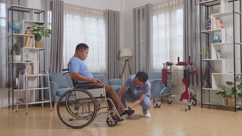 Man in Wheelchair Receives Home Medical Care
