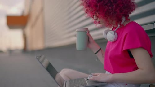 Young Adult with Laptop Working Outside