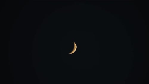 Crescent Moon In The Night Sky.