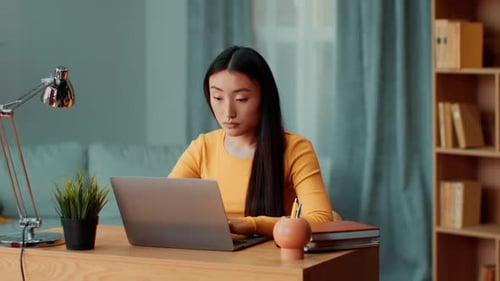 Young Woman Works at Laptop then Leans Back Relaxing