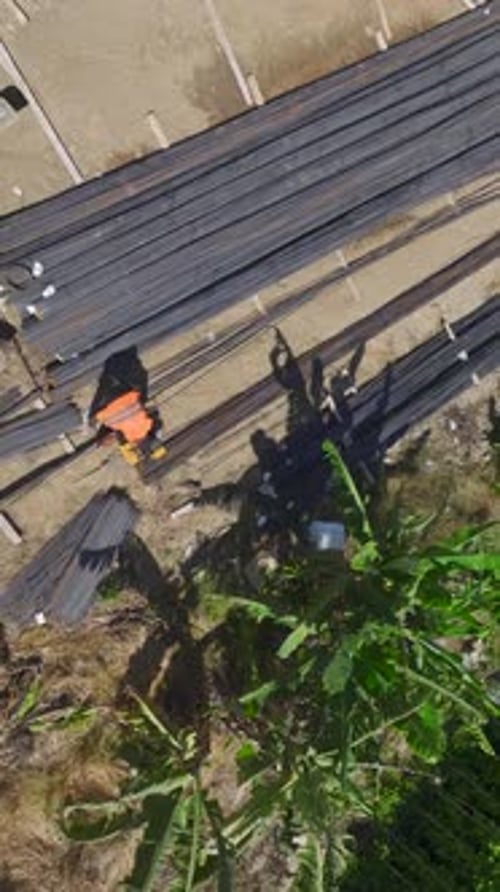 Construction Workers Cutting Rebar on Site Aerial Shot