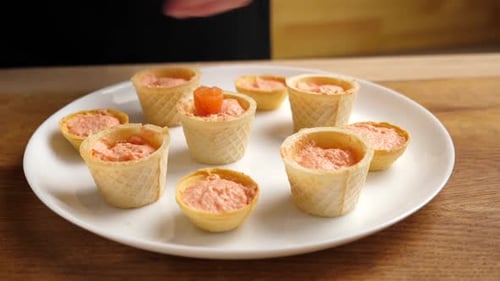 Appetizers Being Prepared with Orange Topping