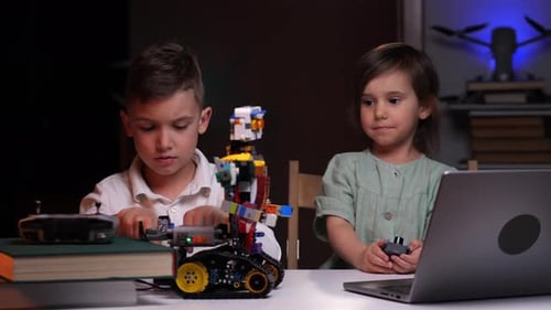 Der Junge und das Mädchen bauen einen Roboter und nehmen Messungen mit Spezialgeräten vor