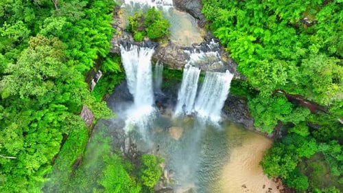 A waterfall in a beautiful tropical forest. Drone view.