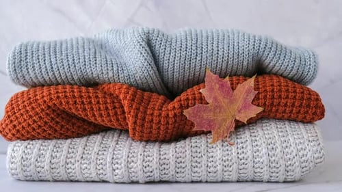 Stack of Sweaters with Fall Maple Leaf