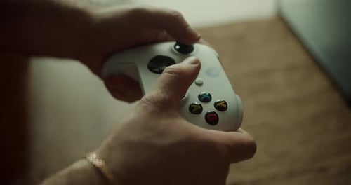 Man Gamer Hands Holding Modern Console for Play Station Closeup Guy Playing Video Games