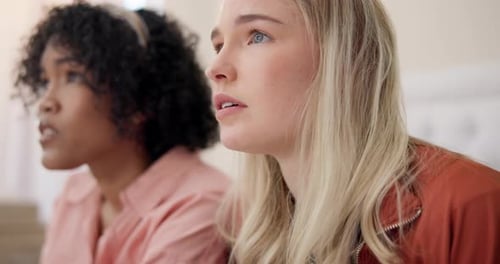 Women Reacting to Scary Movie with Spilled Popcorn