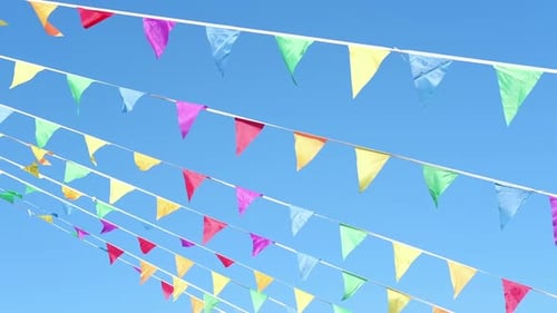 Colorful Bunting Flags Waving Against Blue Sky