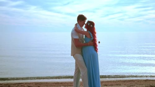 Expecting Parents on Beach. Pregnant Couple Touching Belly with Love and Care