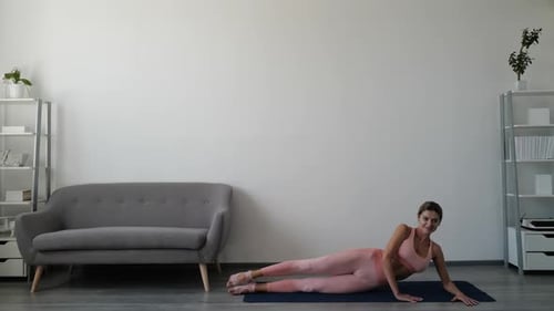 Attractive Woman Doing Leg Lifts in Home Gym