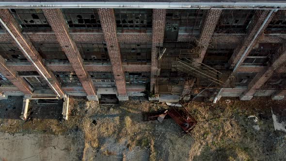 Descending aerial beside brick old factory building, fire escape ...
