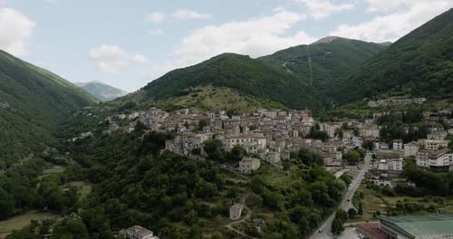 Aerial view of town surrounded by mountains, Italy.