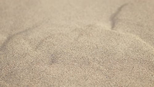 Sand falling down dune in desert
