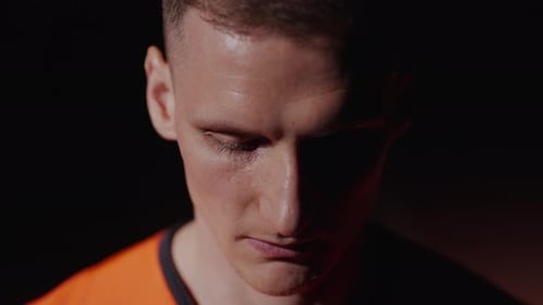 Confident Sportsman Rising Eyes And Looking At Camera Cinematic Portrait In Darkness Sport