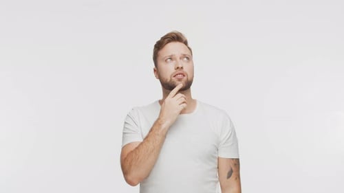 Thinking Young Man Over Vibrant Background Studio Portrait of Expressive Handsome Person