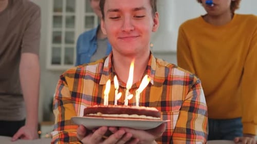 Young Man Celebrates Birthday with Friends