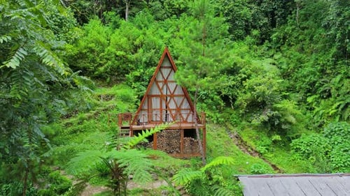 Scenic view of modern eco-friendly wooden lodge tucked away in vibrant green valley