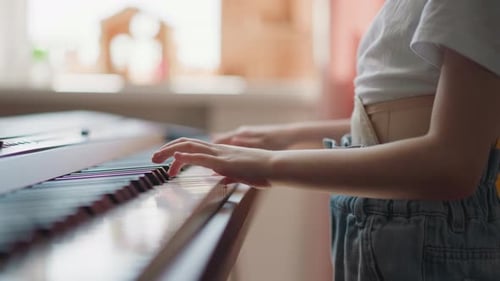 Child Plays Piano at Home in Bright Room