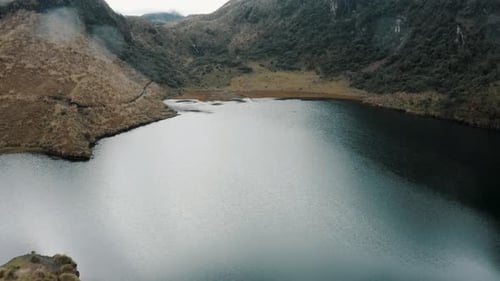 Calm Waters Of The Lake And Scenic Mountains In Cayambe Coca National Park In Ecuador - drone shot