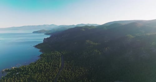 Wonderful scenery of mountainous landscape covered with pine trees. Beautiful peaceful lake