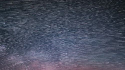 Startrails of Stars in Starry Night Sky with Milky Way Galaxy Trails Background Astronomy Time Lapse