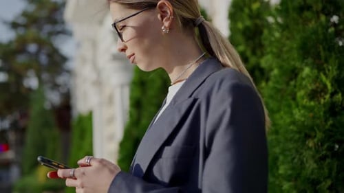 Stylish Woman Using Smartphone in Urban Setting