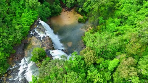Aerial view over a waterfall in a beautiful tropical forest.
