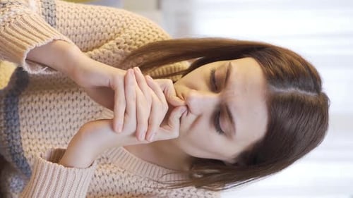 Young Woman Thinking and Touching Her Face