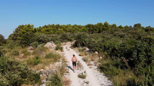 Trail Runner Running on Rocky Path in Nature