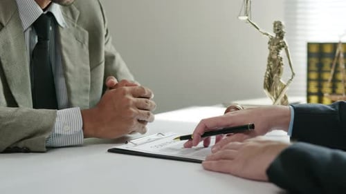 Lawyers Reviewing Contract Documents in Office