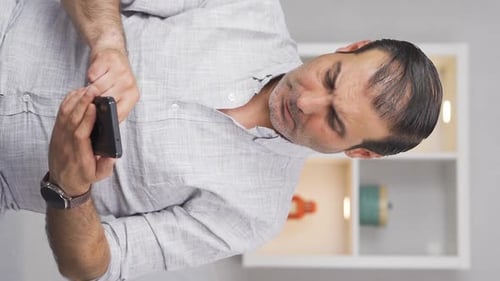 Upset Man Using Smartphone at Home