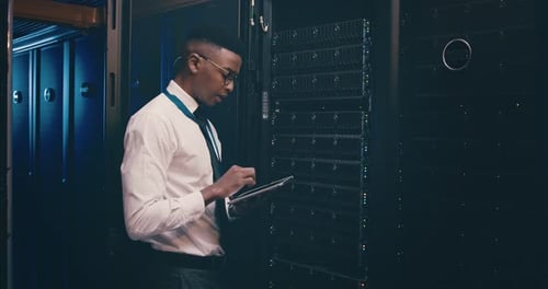 Black man in data center with tablet, inspection or network maintenance with engineer in database