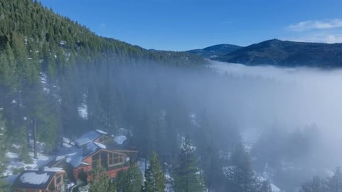 Mountain Cabin Emerging From Fog Above Pine Forest at Palisades Tahoe California USA