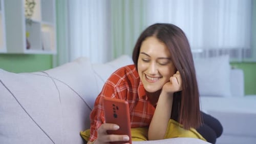 Excited and cheerful young woman chatting facetime.