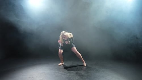 Contemporary Woman Dancer Posing on Black Background with Smoke Adult Female Artist Performer