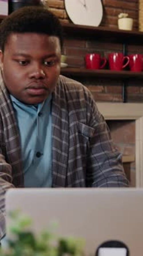 A Focused Individual is Highly Engaged in Their Work Within the Comfort of Their Home Workspace