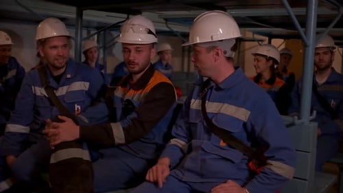 Serbia, Belgrade - June 20, 2023: Workers in uniform are sitting in room. Clip. Team of workers