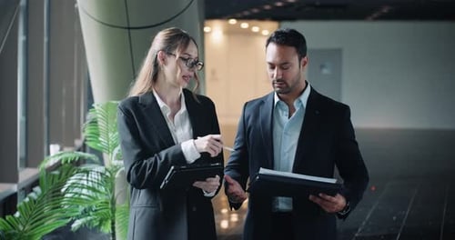 Business Colleagues Discussing Data on a Tablet Indoors